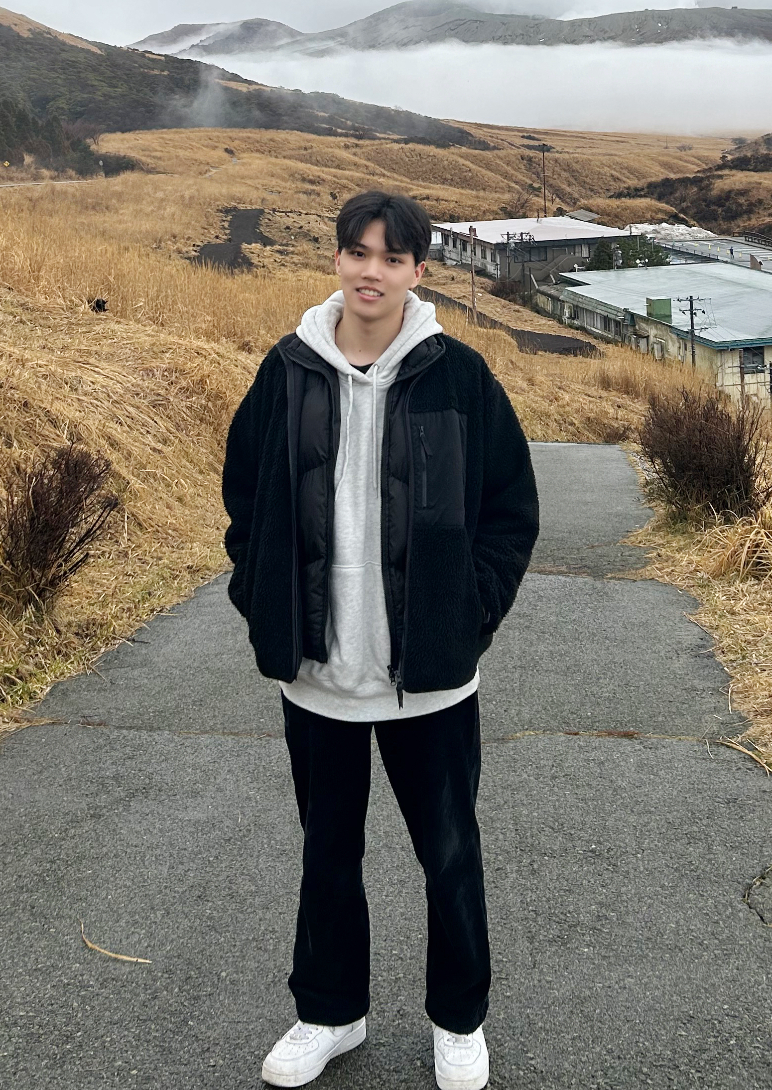 Kuang-Ting (Tim) Tu standing in a mountain landscape.